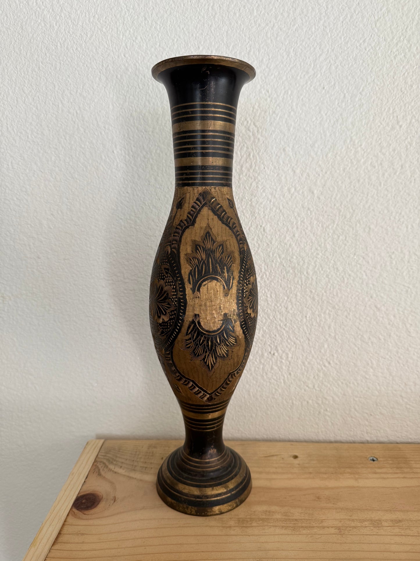 Decorative vase with intricate patterns on a white wall