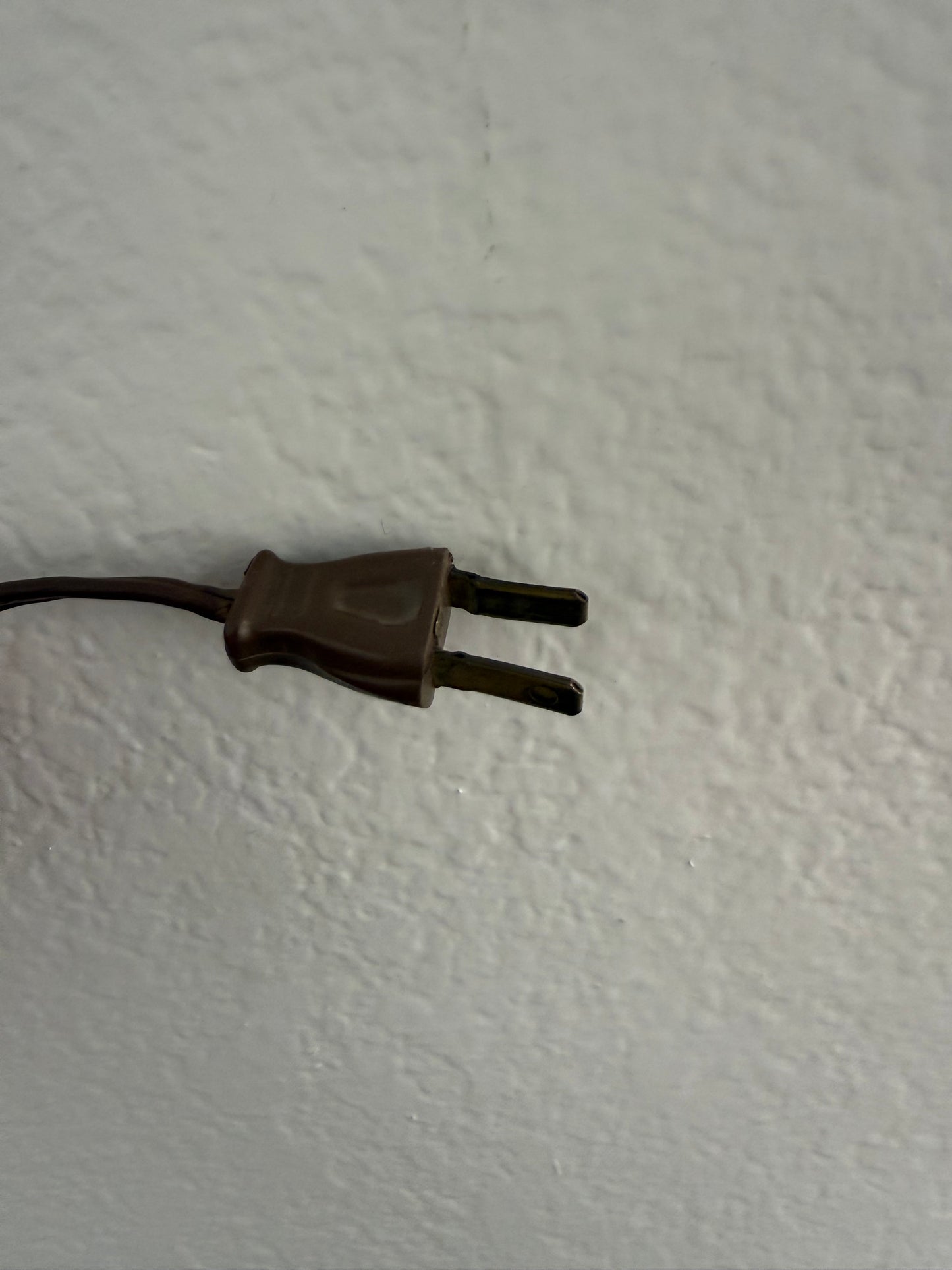 Brown plug on a white wall