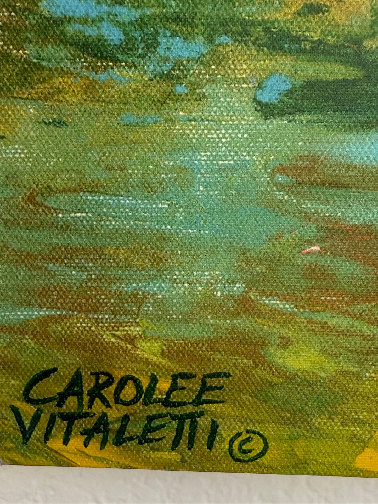 Close-up of an abstract painting with a signature on the right corner.