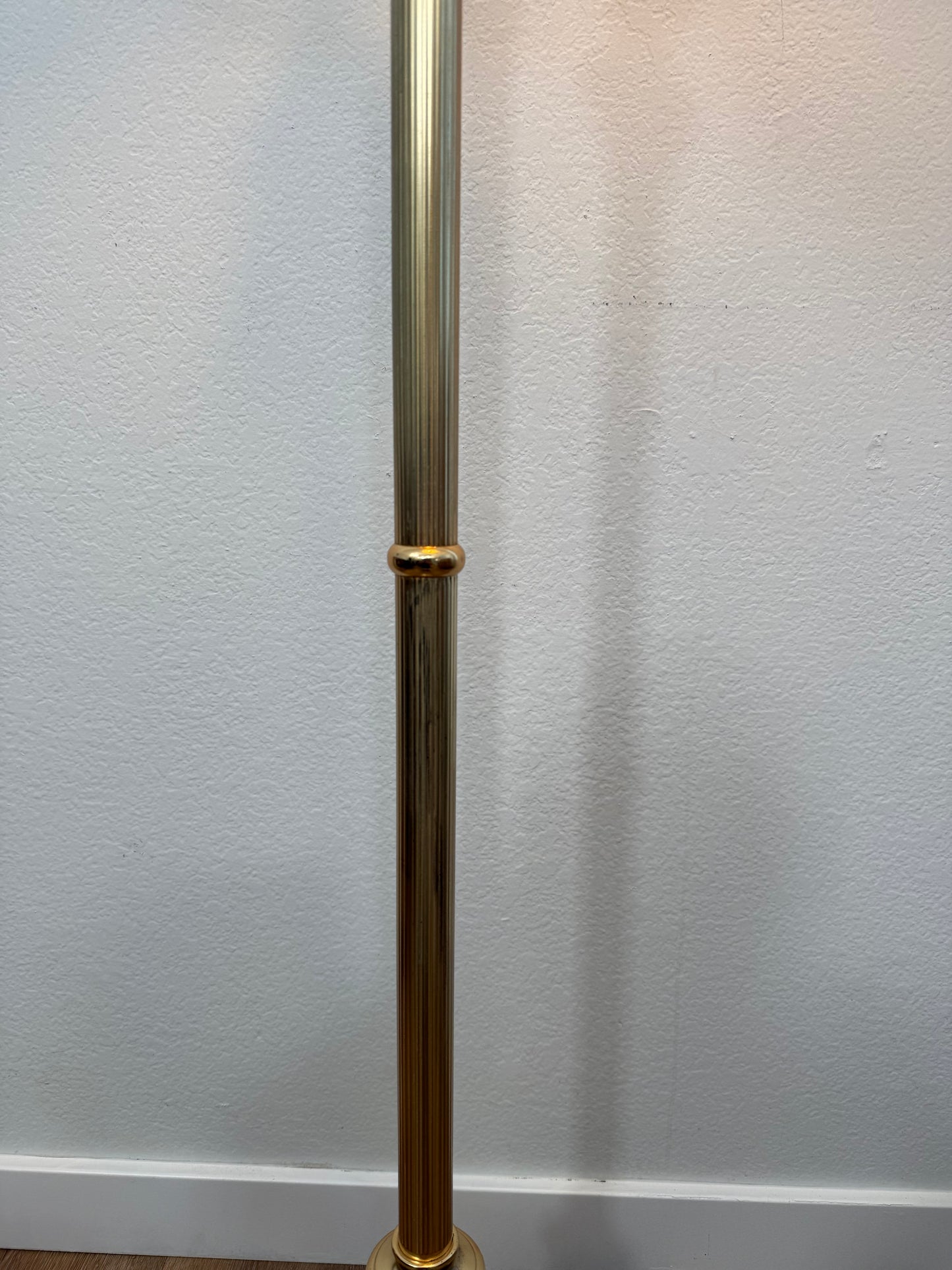 gold rod against a white wall