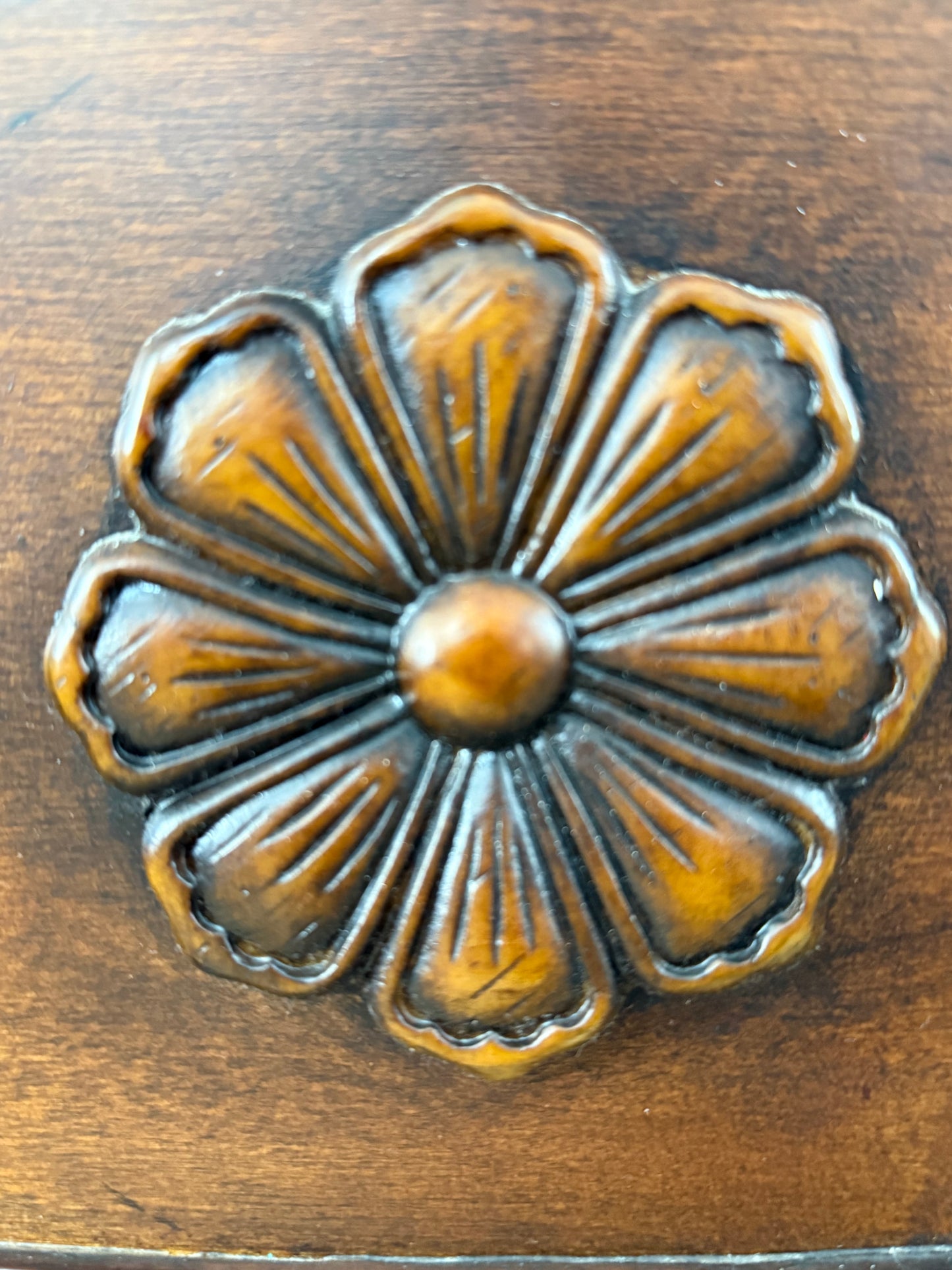 Decorative wood flower design on a wooden surface