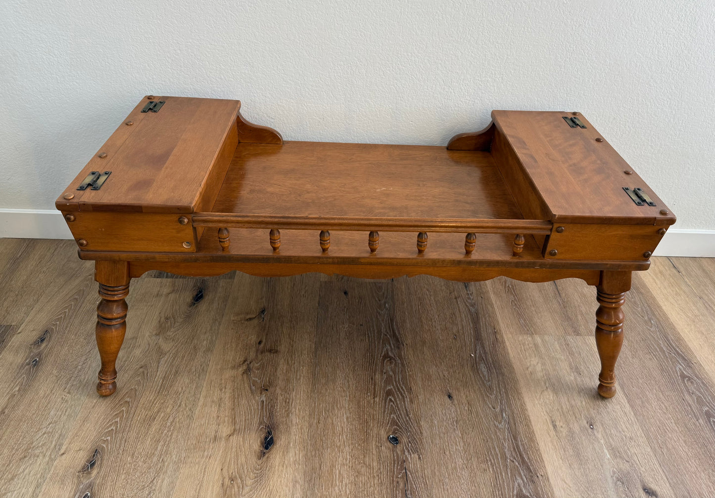Wooden coffee table with two doors at each end sitting on a wooden floor
