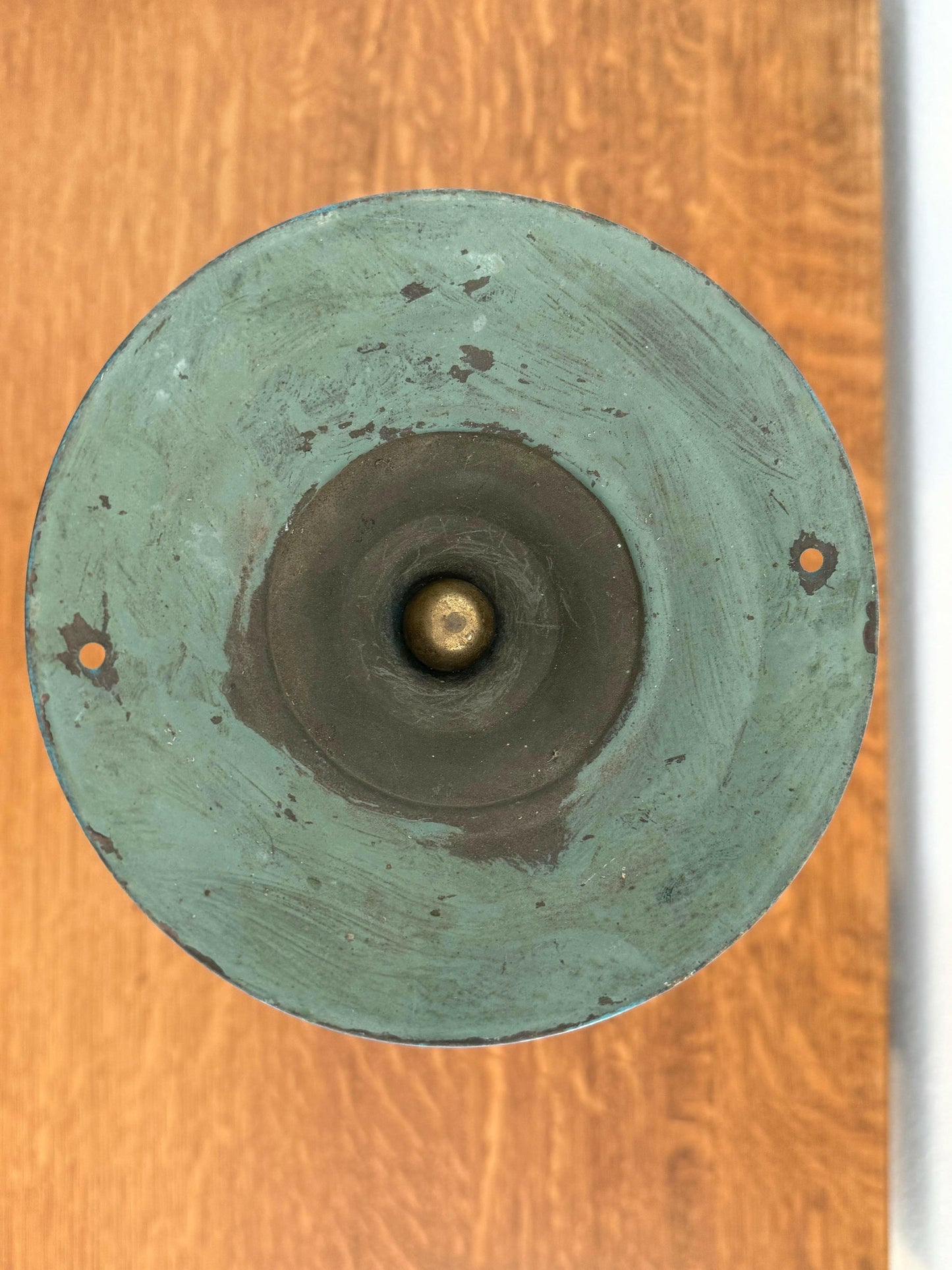 round metal on wooden surface