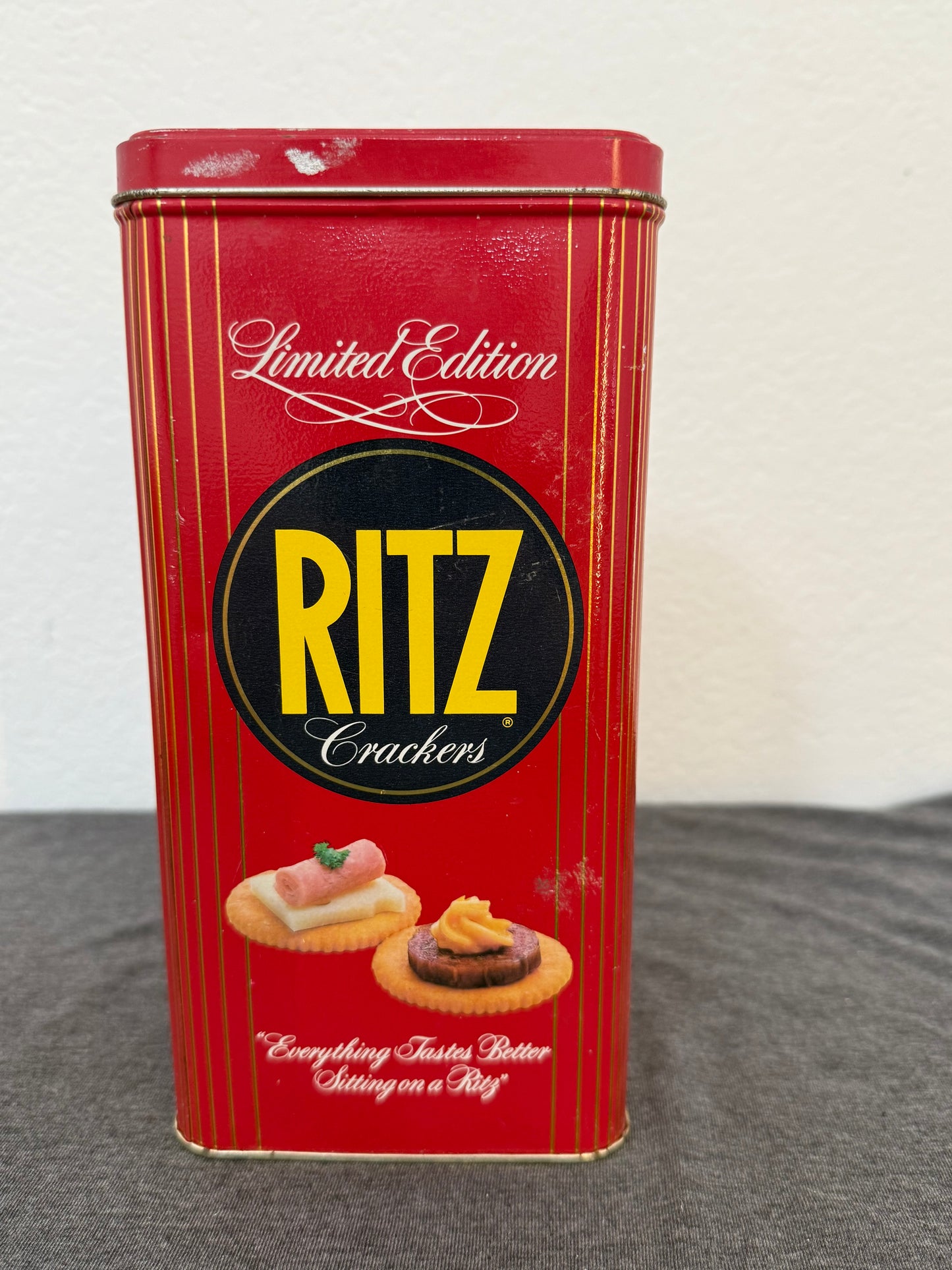 Red Ritz crackers tin on a white and gray background