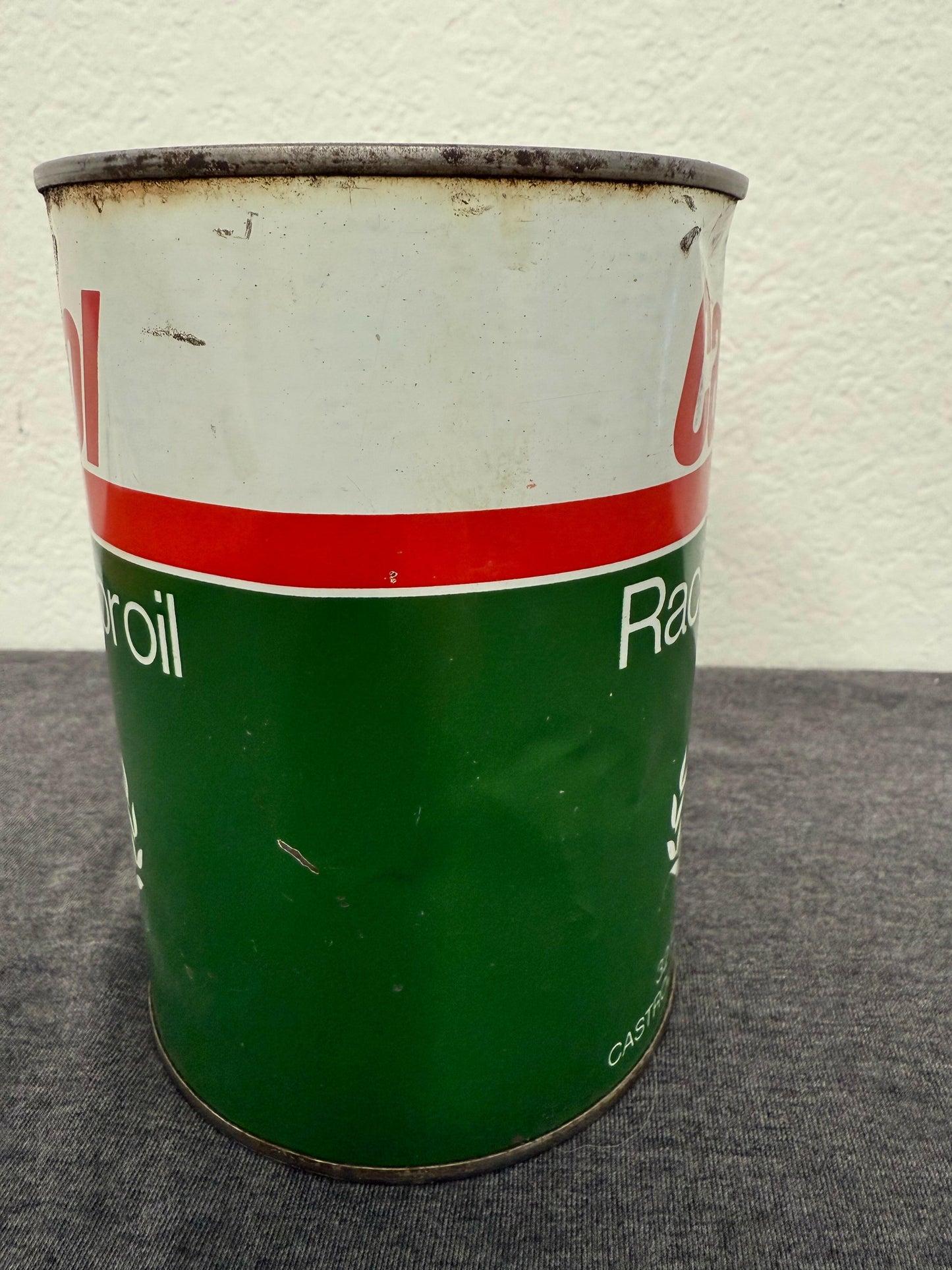 Metal can with green and white label on a textured surface