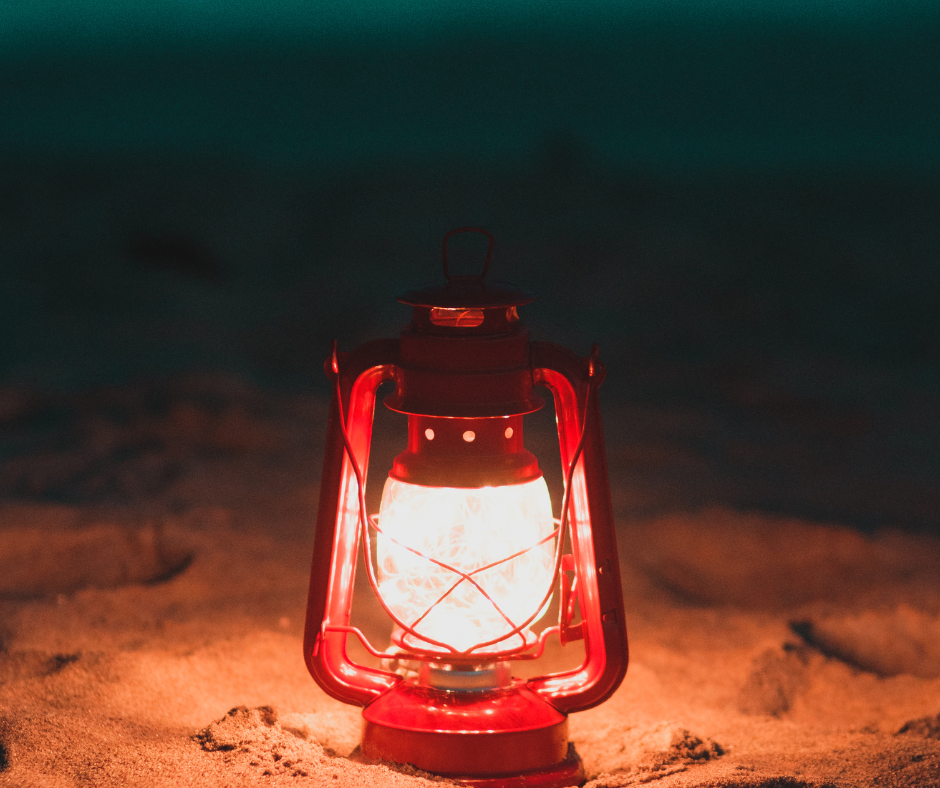 Red lantern on the sand of a beach