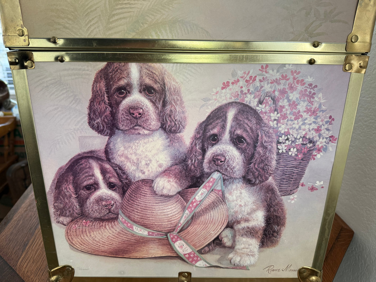 Decorative box with illustration of puppies and a hat on a floral background
