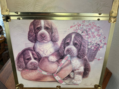 Decorative box with illustration of puppies and a hat on a floral background