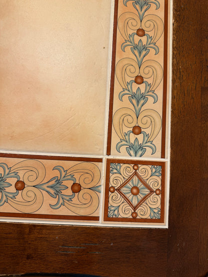 Decorative border with floral patterns on a wooden table