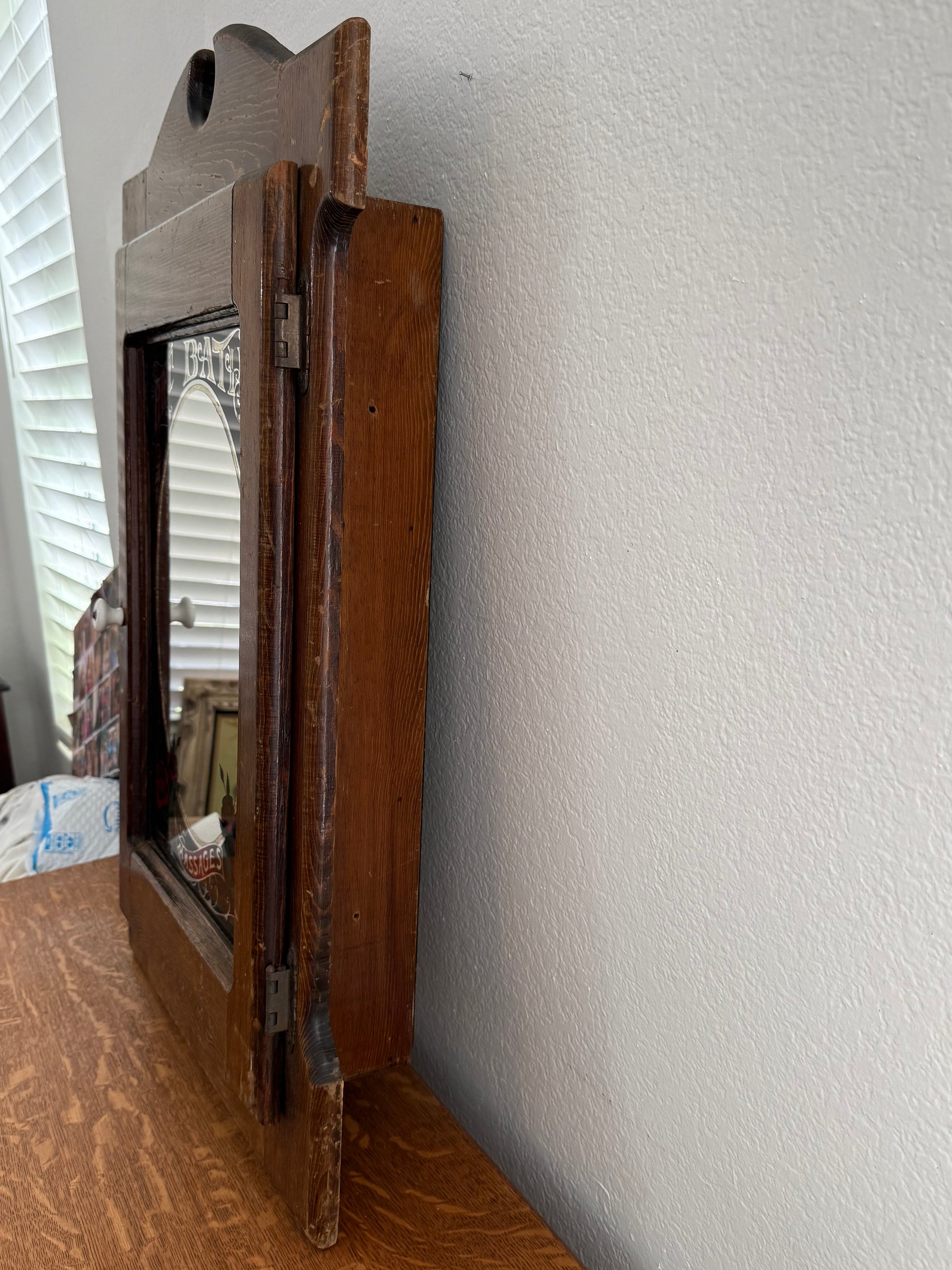 Wooden cabinet attached to a white wall