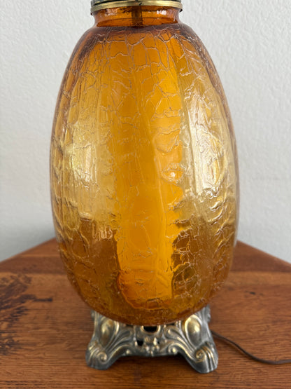 Brown lamp with textured surface and silver cap on a white background