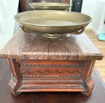 Bronze bowl on a marble pedestal with a wooden base