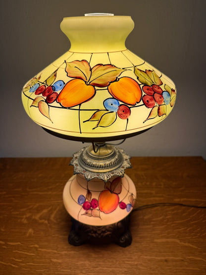 Decorative lamp with fruit design on a plain background