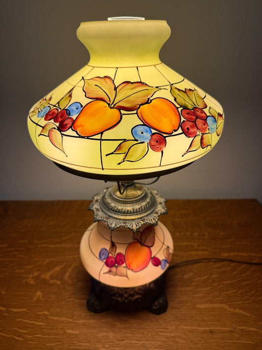 Decorative lamp with fruit design on a plain background