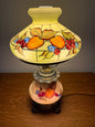 Decorative lamp with fruit design on a plain background