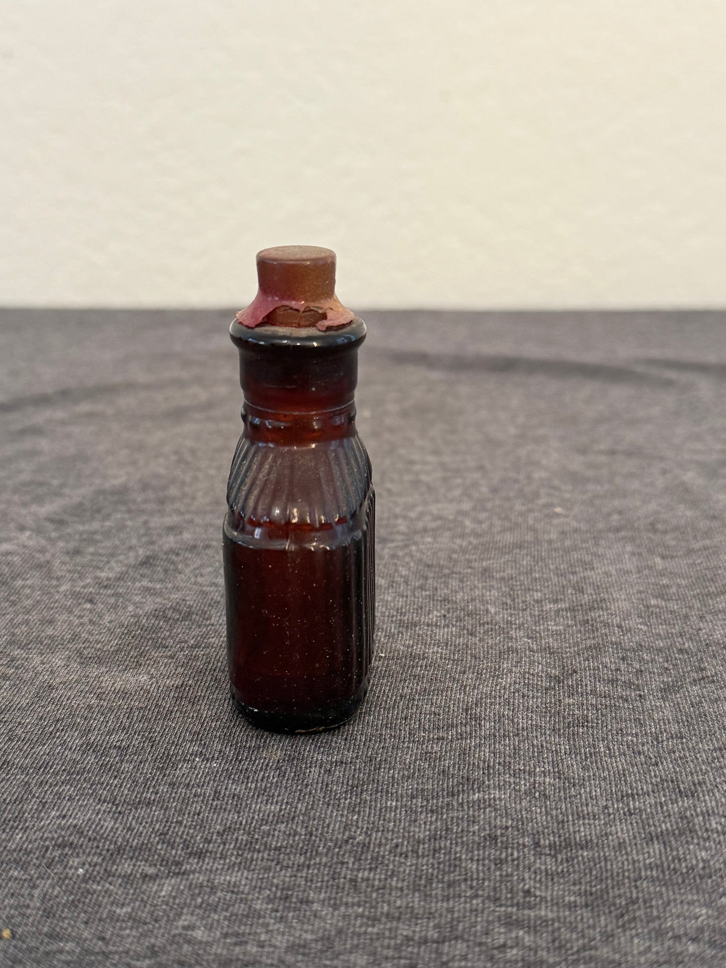 Small brown bottle on a textured gray surface