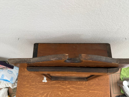 Wooden cabinet with a textured white wall in the background