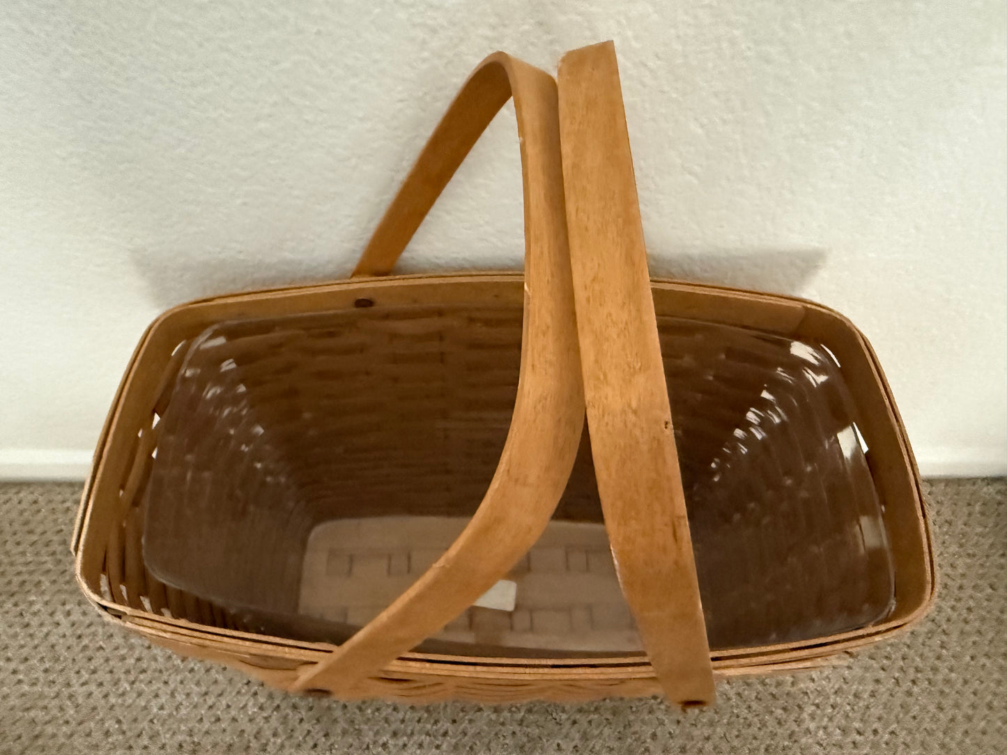 Wicker basket with a handle on a textured surface