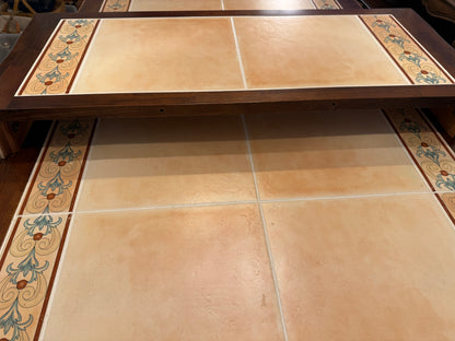 Tiled wood table with decorative border.