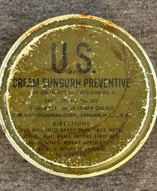 Circular label with 'U.S.' and 'Cream Sunburn Preventive' text on a textured surface.