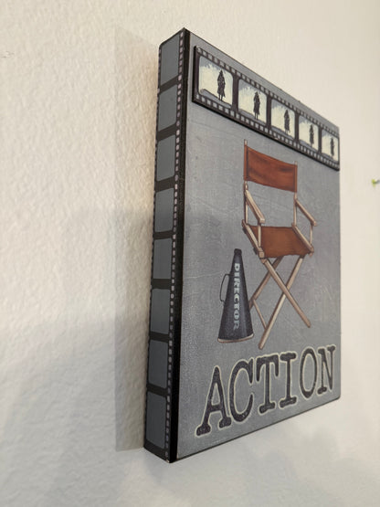 Decorative box with film reel design and 'Action' text on a white background