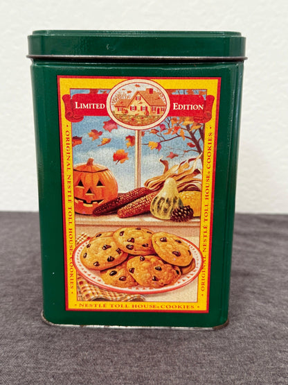 Green cookie tin with colorful label featuring a pie and autumn-themed design on a gray background.