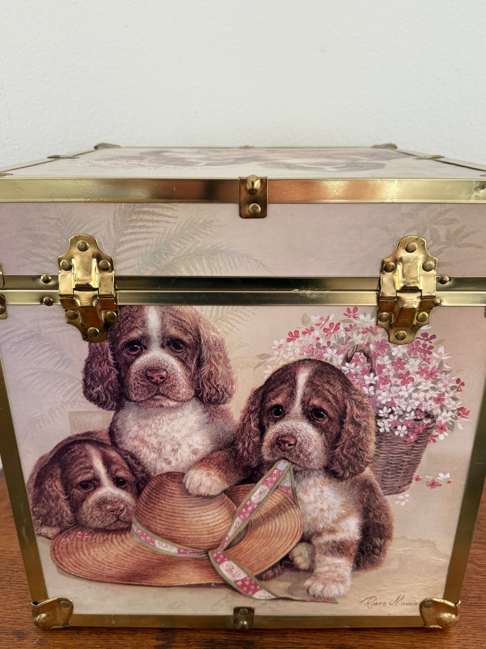 Decorative box with puppy illustration and floral elements on a white background
