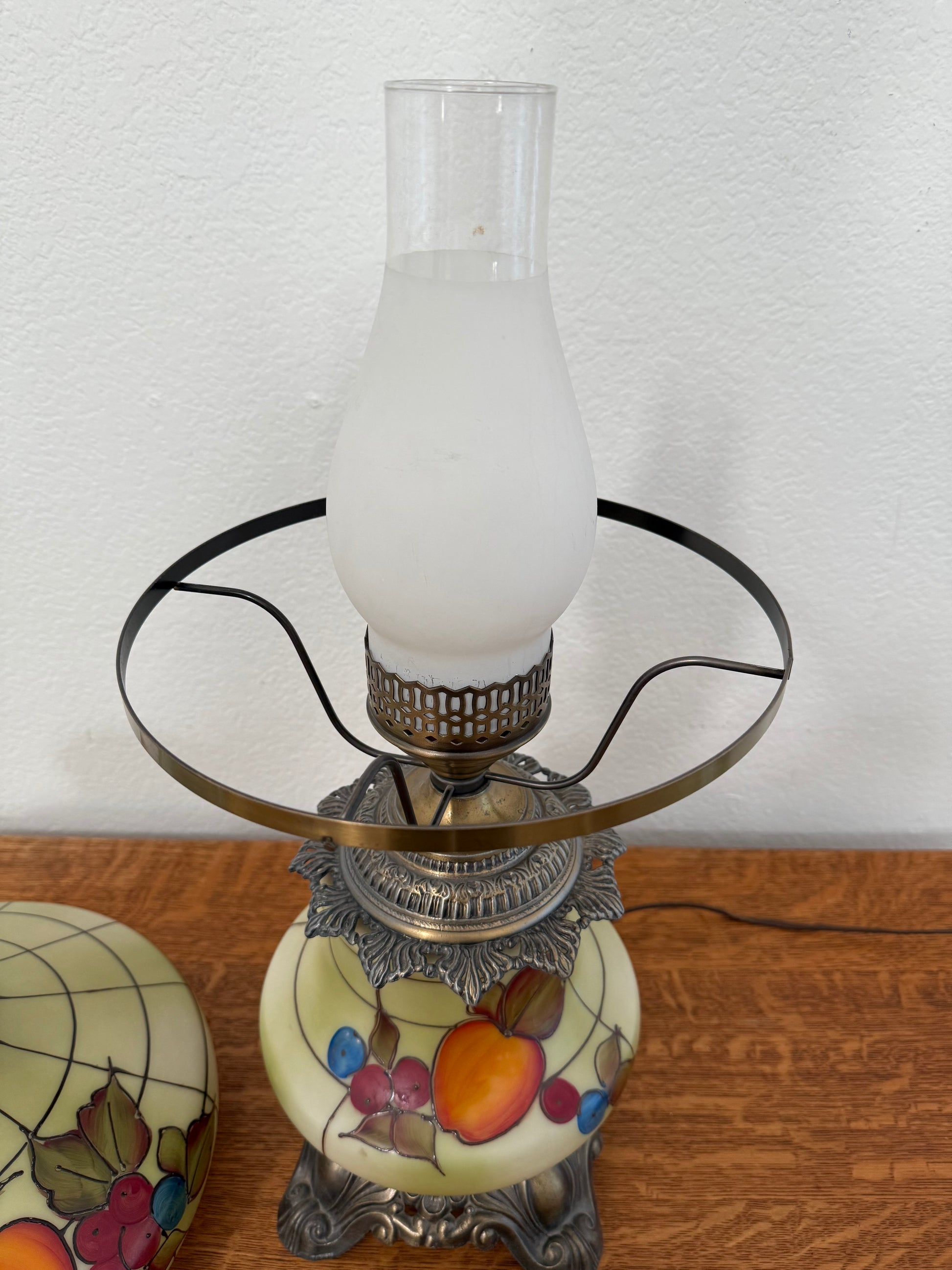 Decorative lamp with a white bulb against a white wall.