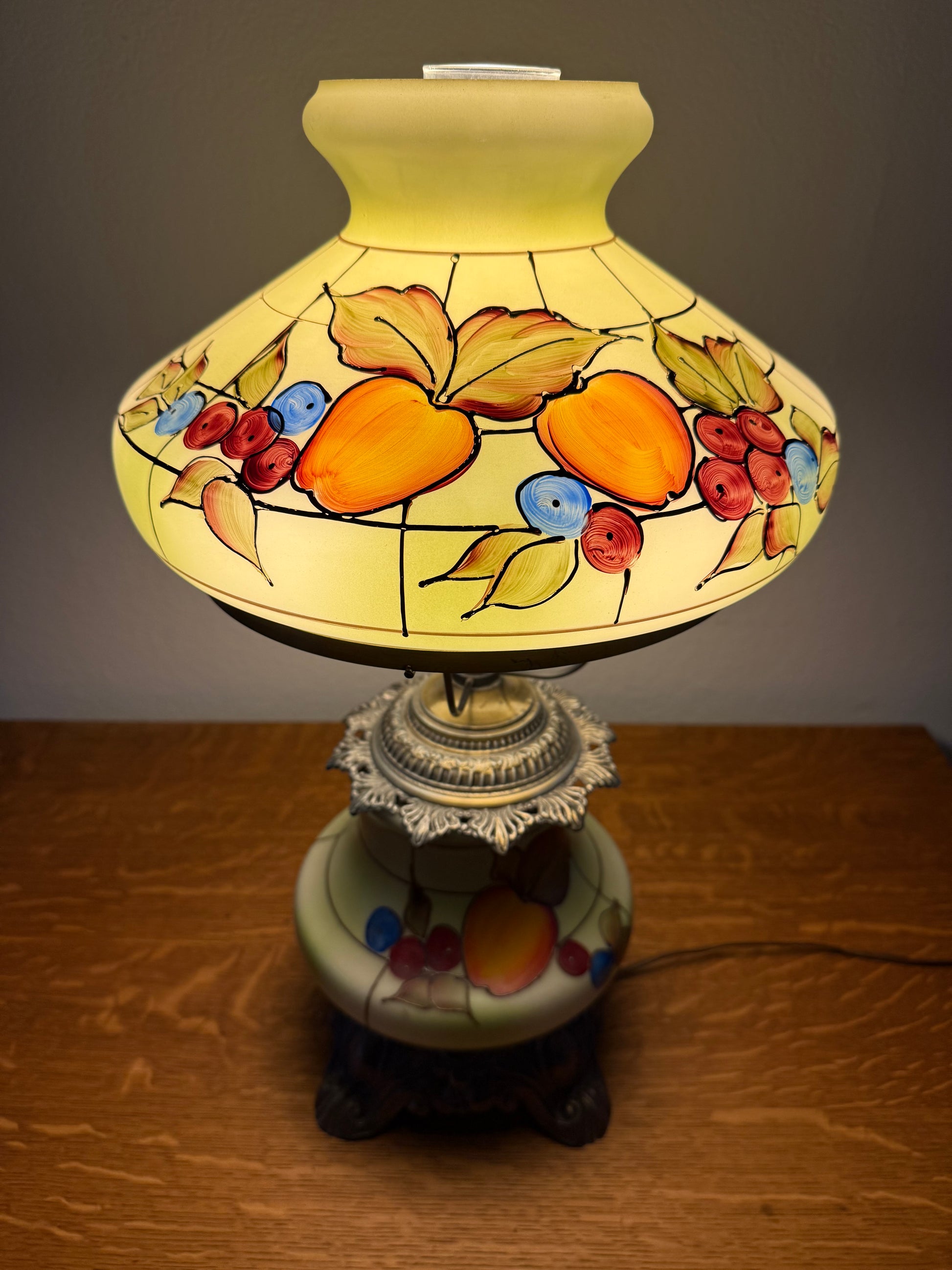Decorative lamp with fruit design on a wooden surface