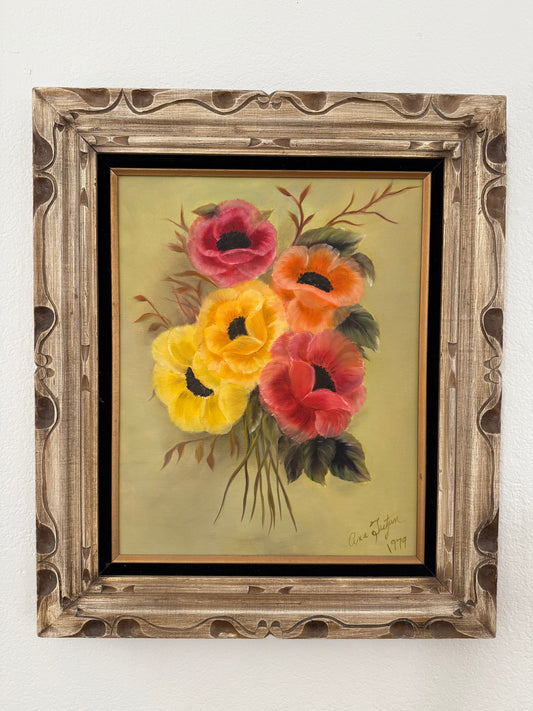 Framed painting of flowers on a white wall
