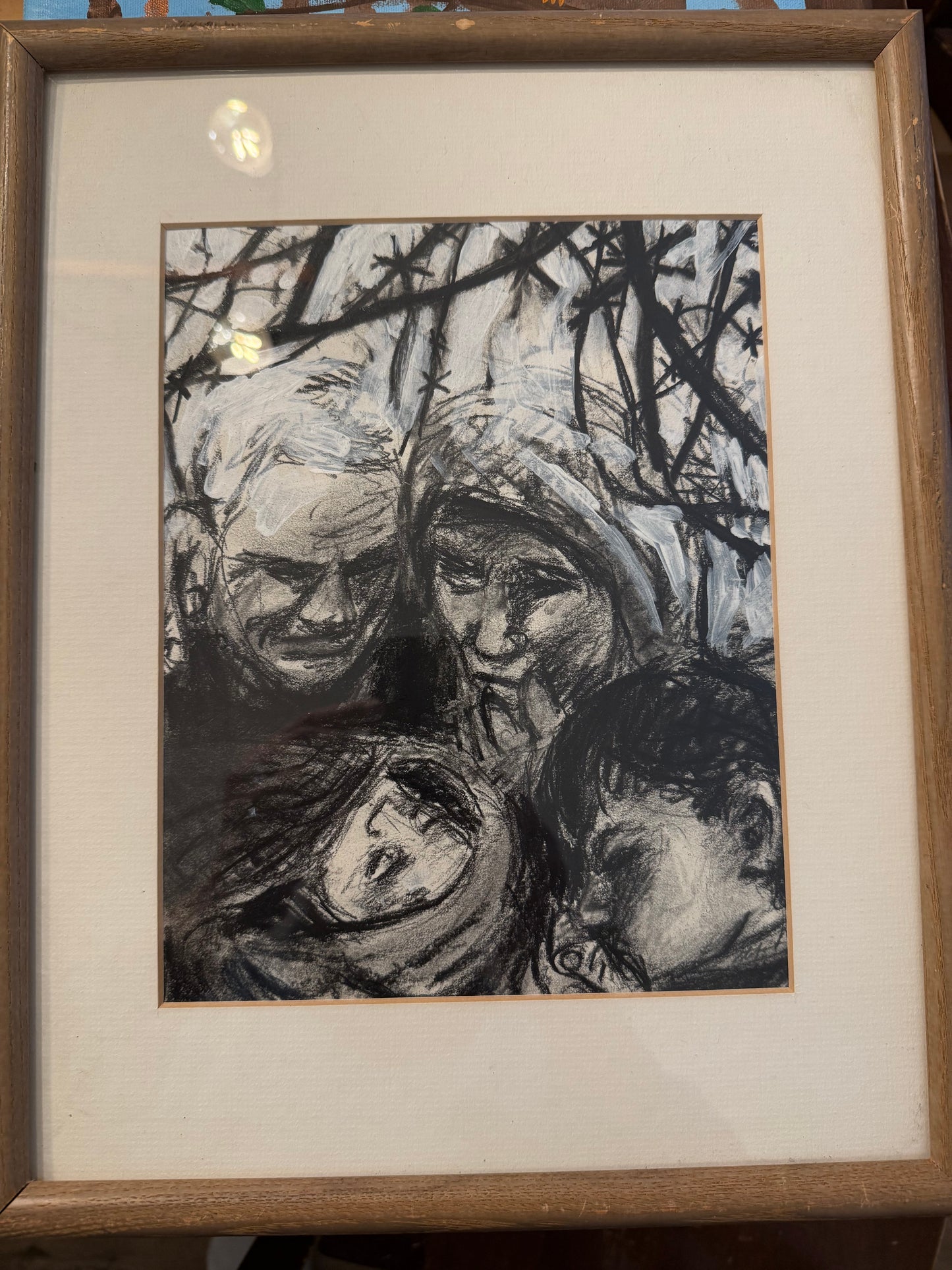 Framed black and white abstract artwork on a textured surface