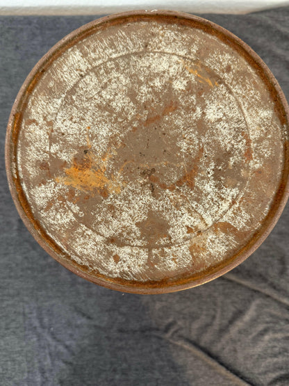 Rust-covered metal object on a textured gray background