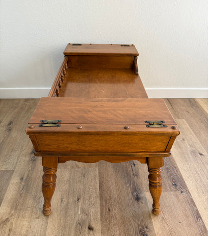 Wooden coffee table with two doors on a wooden floor against a white wall