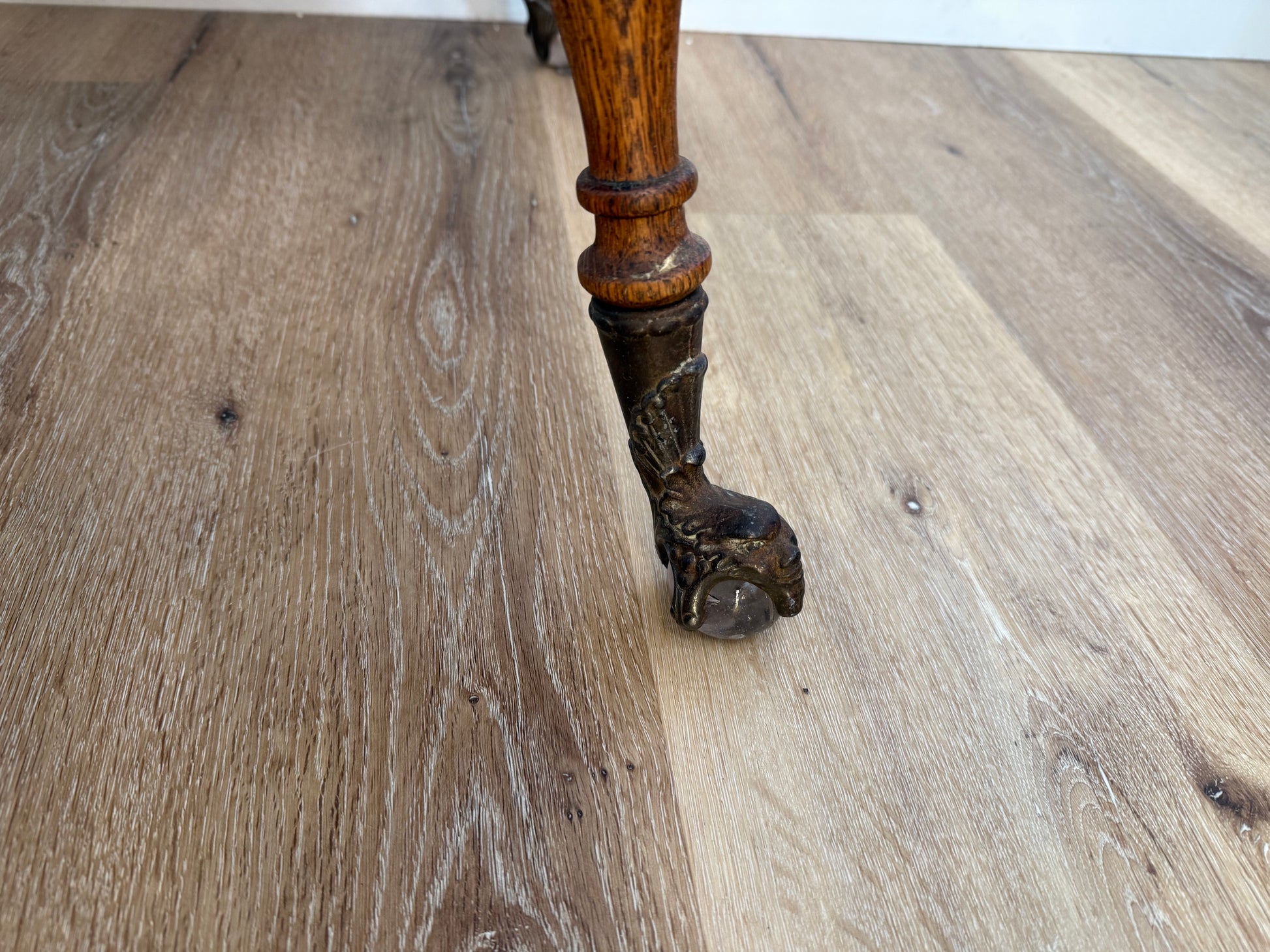 Wooden leg with decorative carvings on a wooden floor