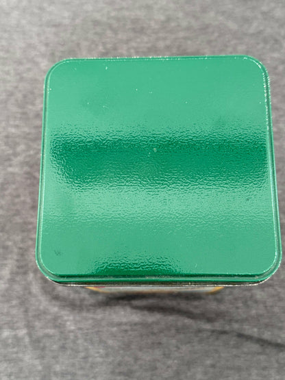 Green metallic square object on a gray background