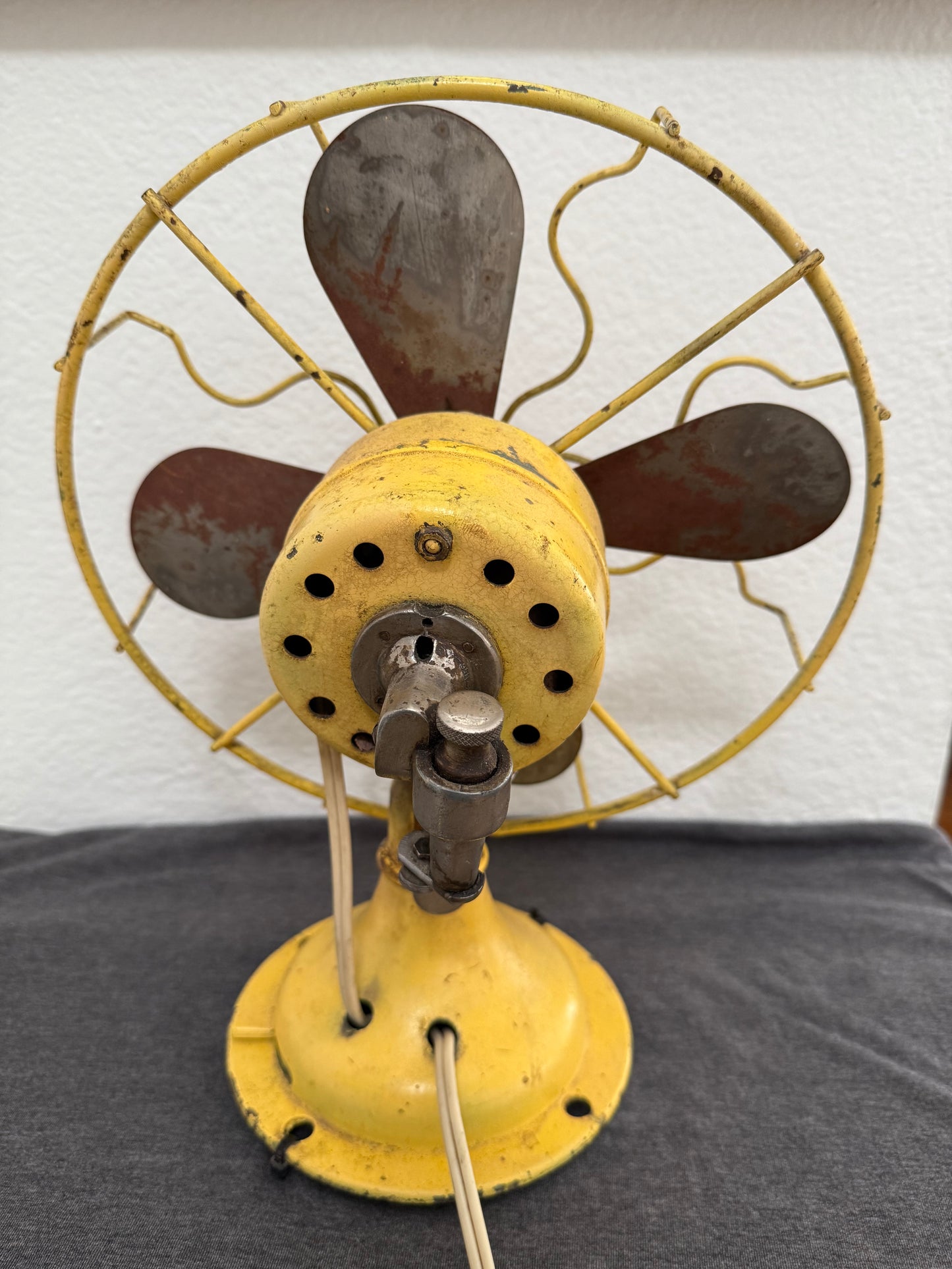 Vintage fan on a wall with a neutral background