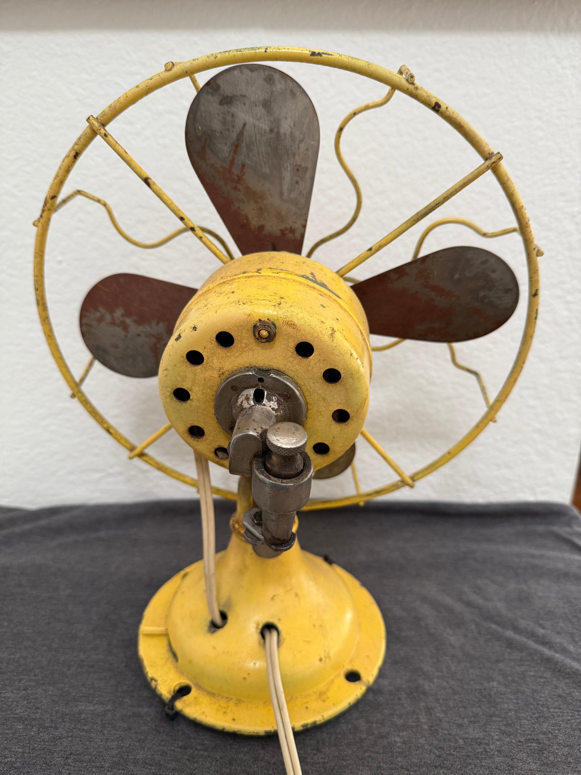Vintage fan on a wall with a neutral background