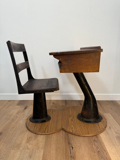 Antique wood school desk with cast iron legs on wooden base