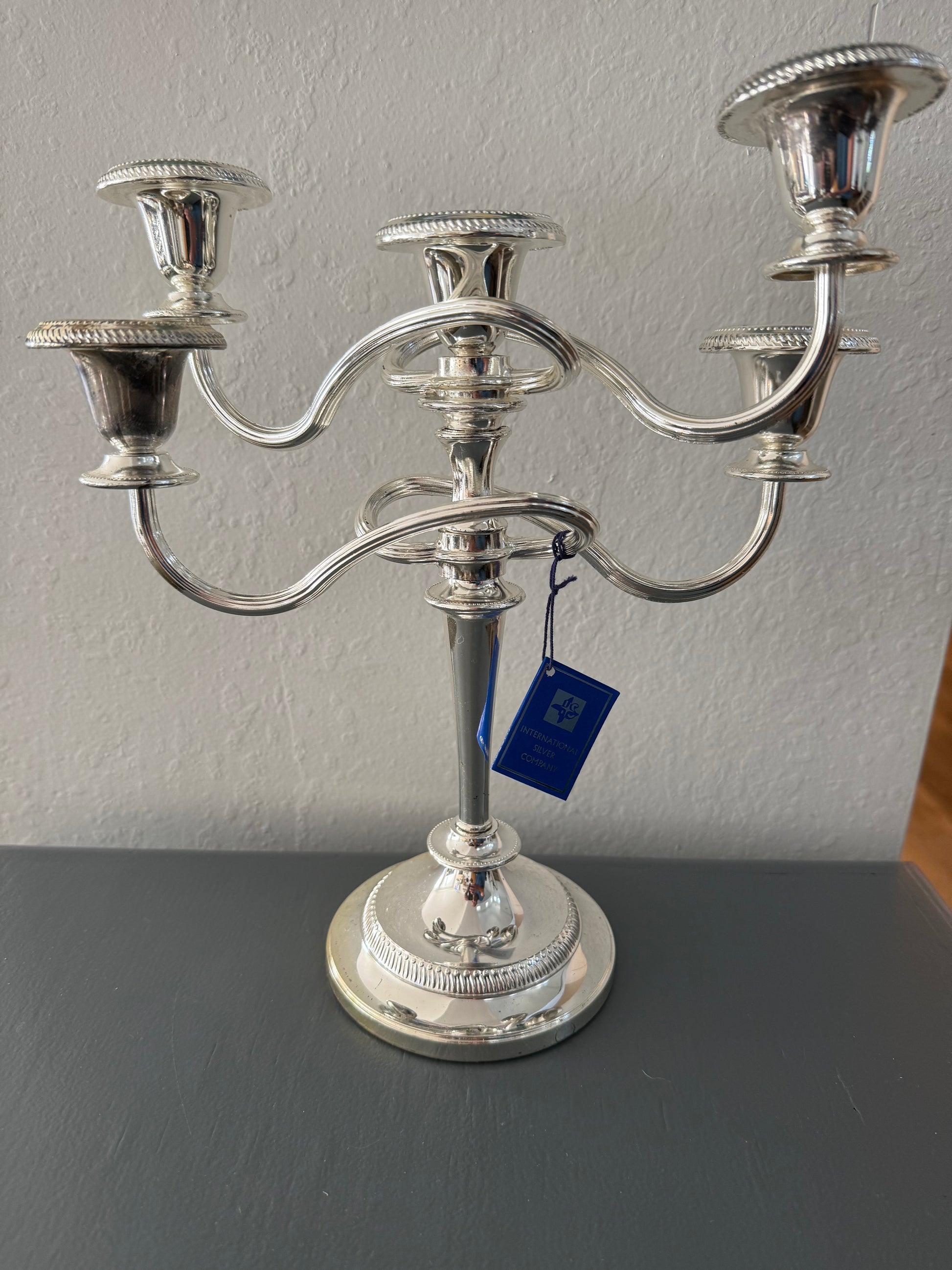 Silver candle holder on a gray surface