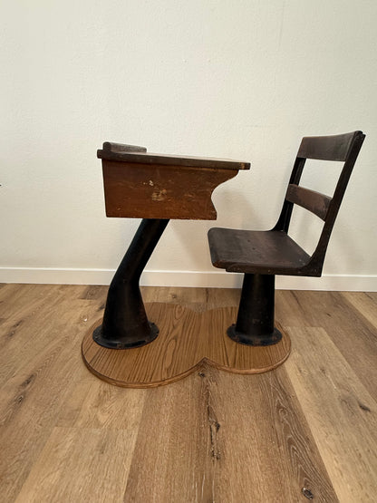 Antique wood school desk with cast iron legs on wooden base