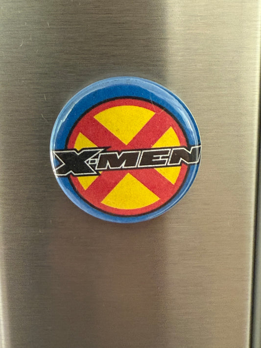 Round x-men logo with red and yellow design on a metallic surface