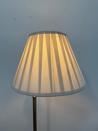 Lampshade with pleated design on a plain background
