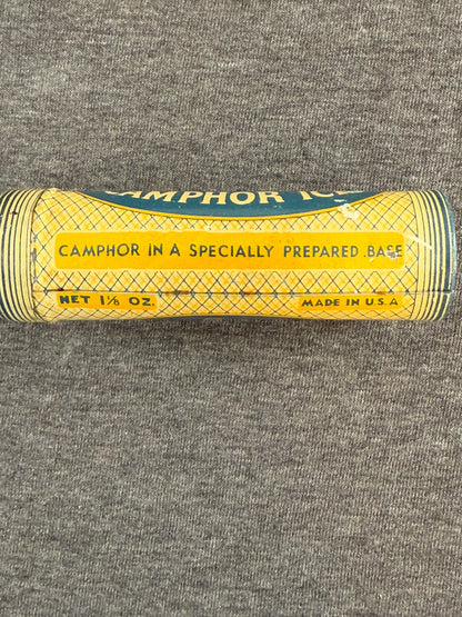 Tall cylindrical container with yellow label on a gray textured background