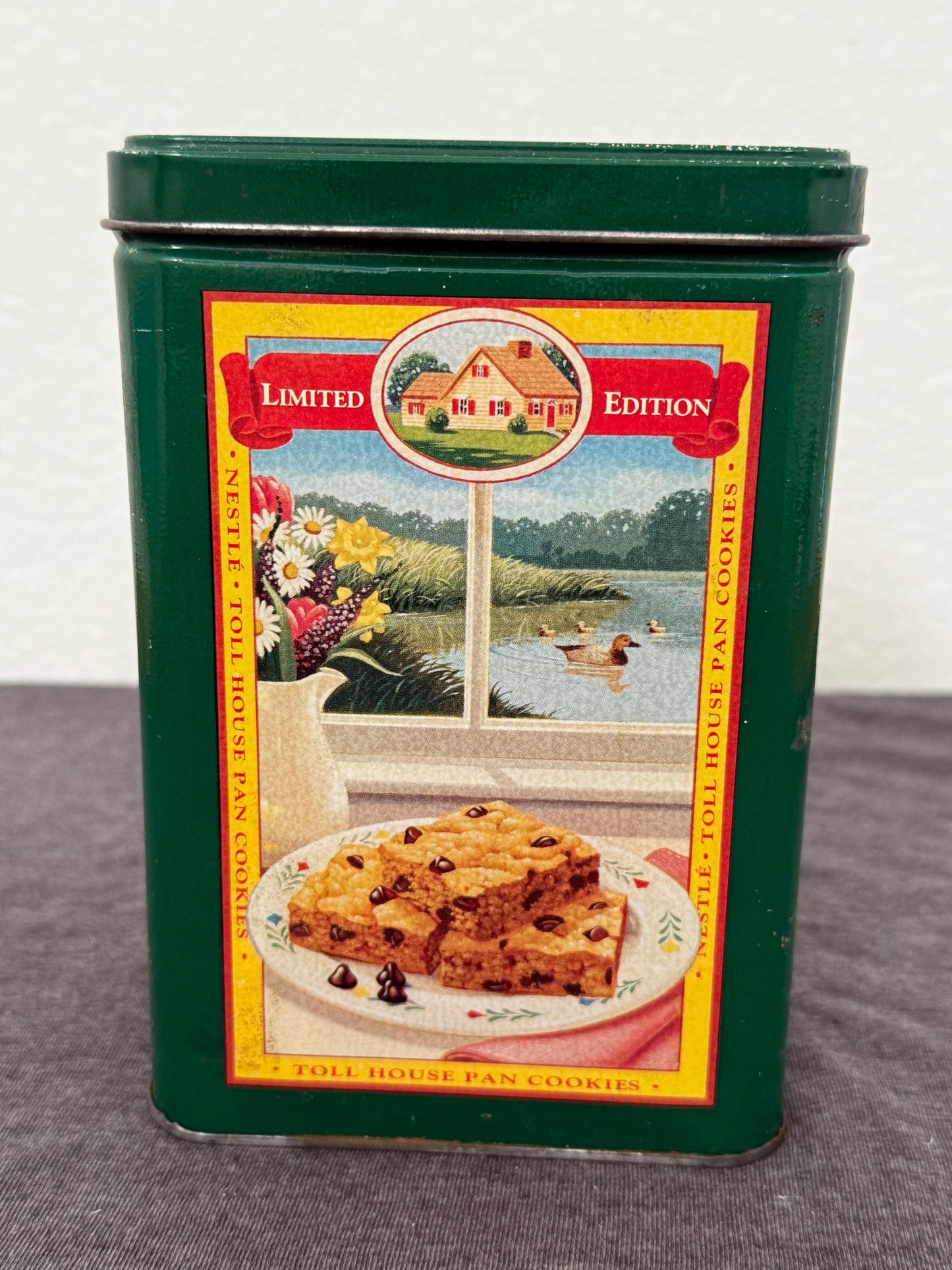Vintage Nestle Toll House Pan Cookies tin with colorful label on a white background