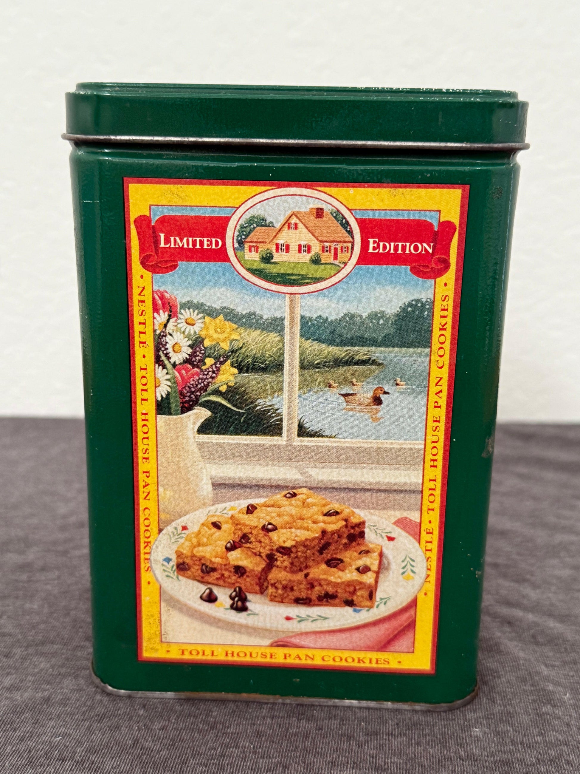 Vintage Nestle Toll House Pan Cookies tin with colorful label on a white background