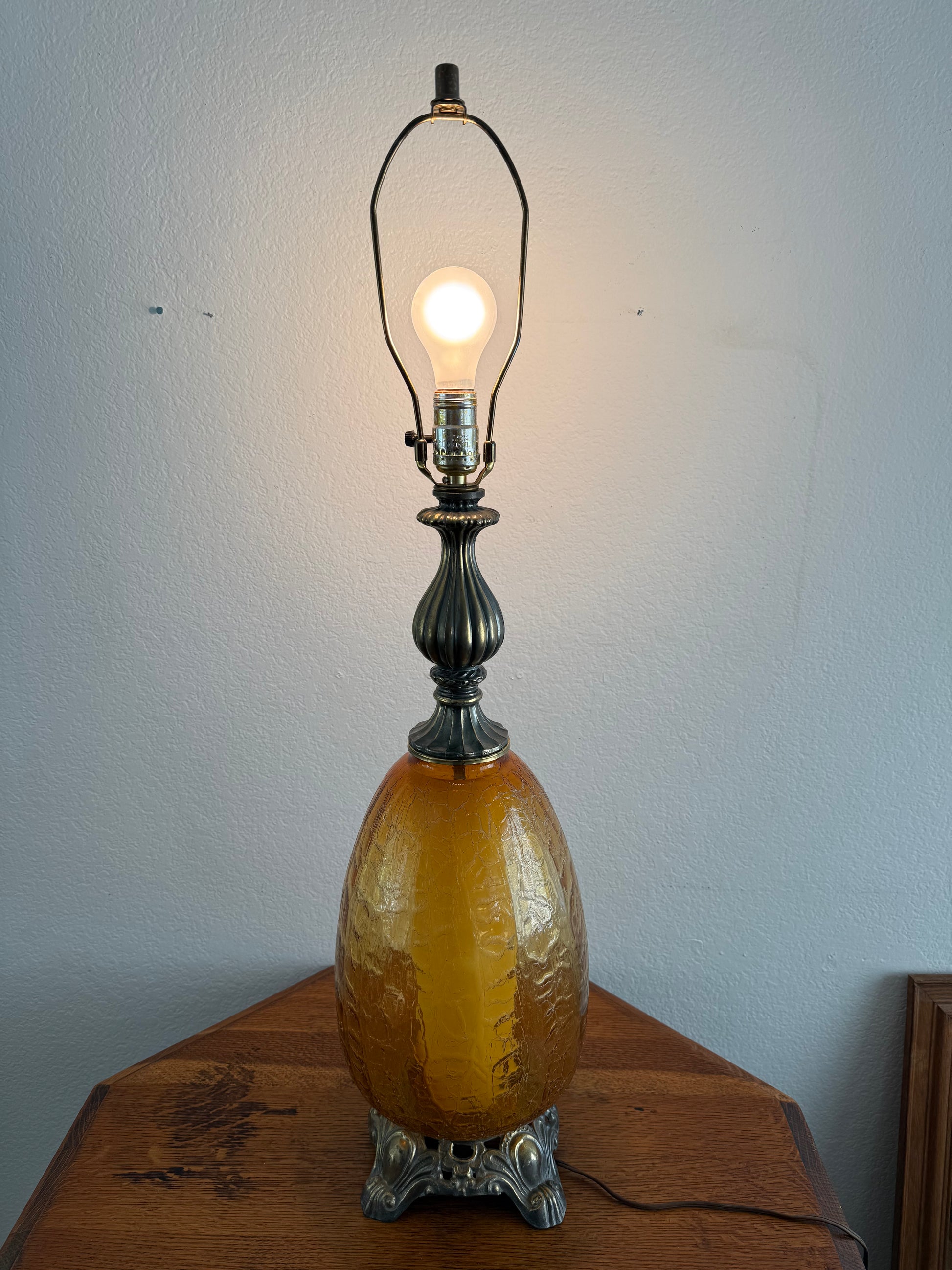 Vintage-style lamp with a glowing light bulb on a plain background
