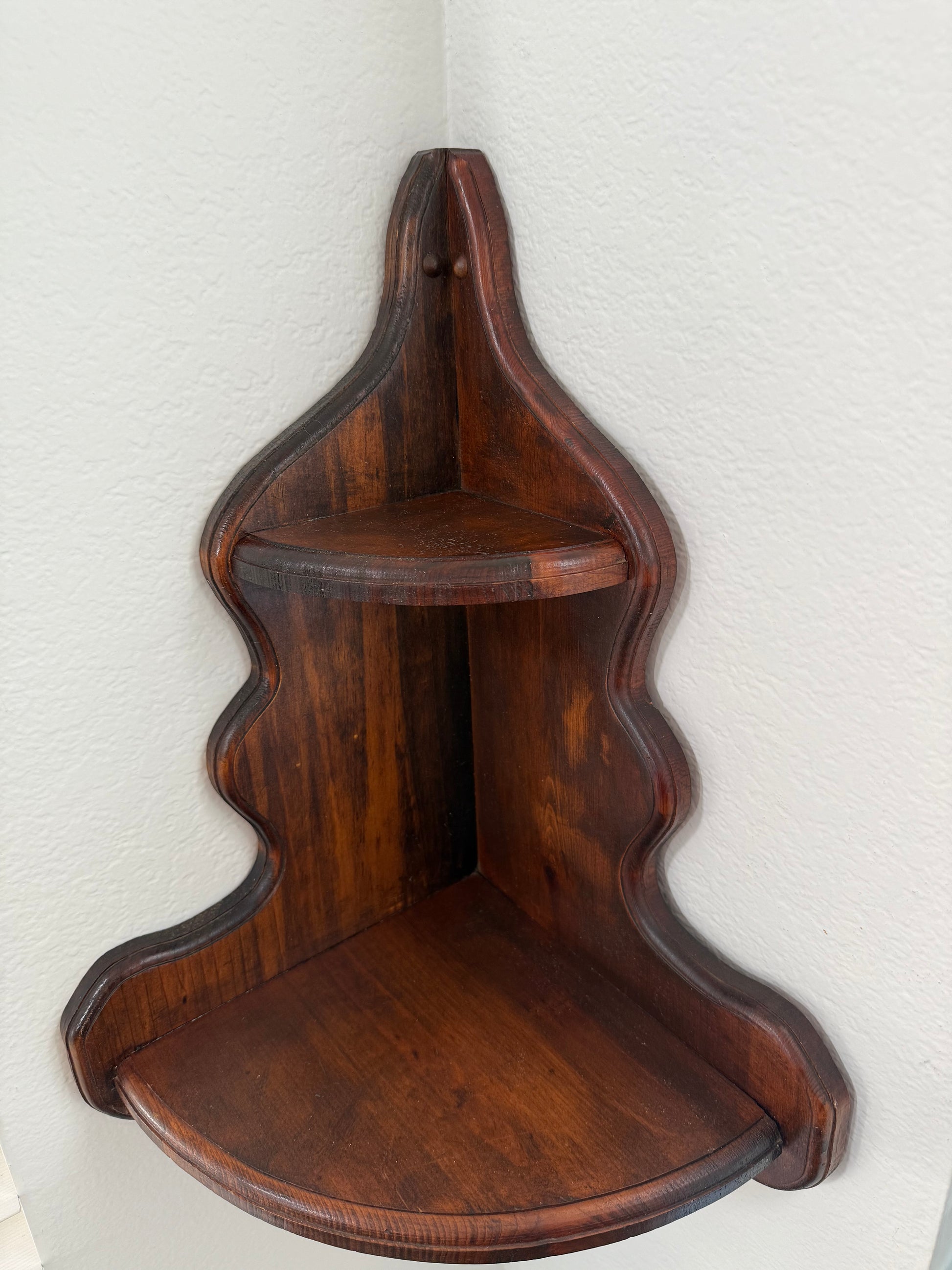 Wooden shelf with wavy design on a white background