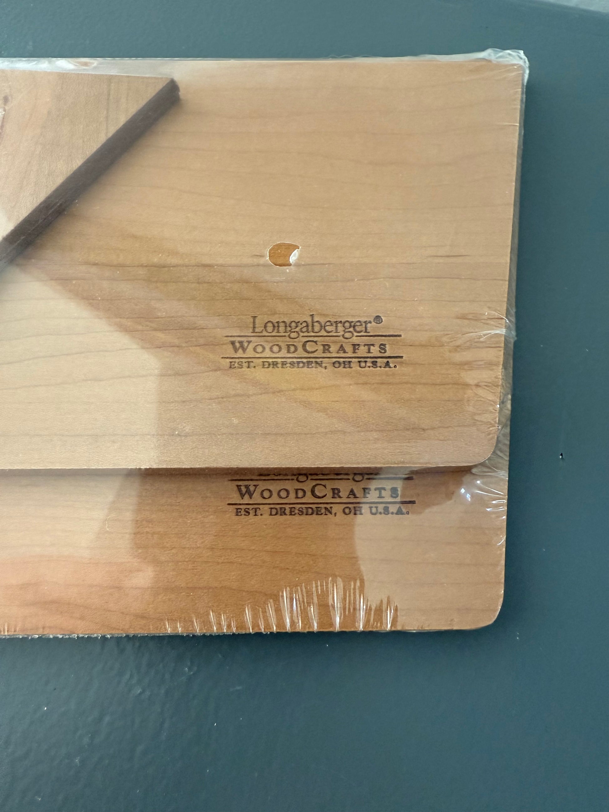 Wood stamped with 'Longaberger WoodCrafts' branding on a dark surface.