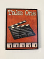 Decorative sign with clapperboard and filmstrip design on a wooden background