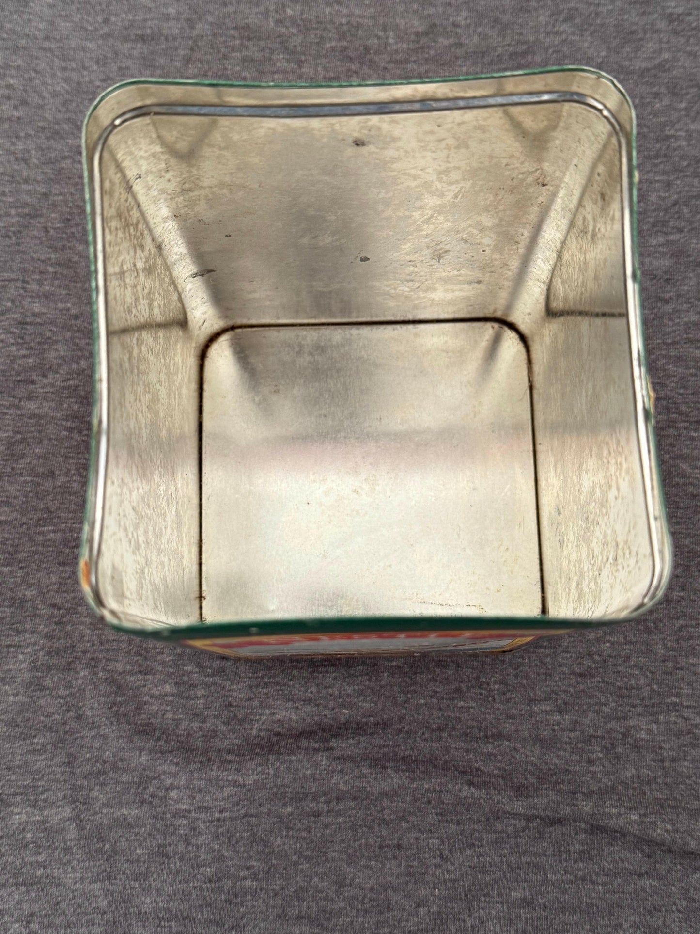 Metallic square object on a gray background
